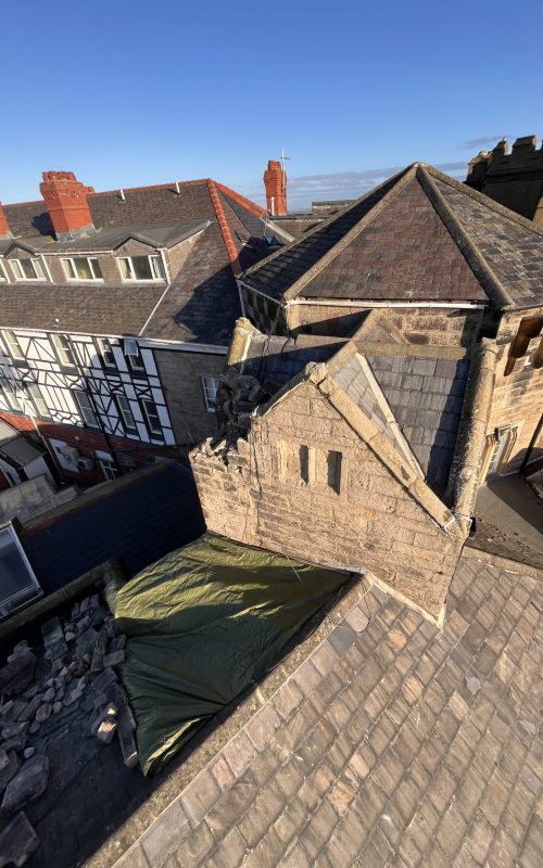 Unique castle with slate roof emergency repair by Maintenance Free Roofing
